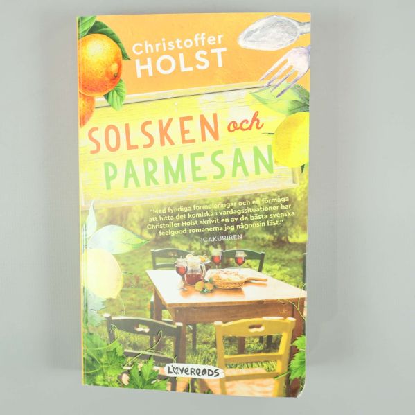 Framsidan på Solsken och parmesan med färgglada citroner, bord och mat