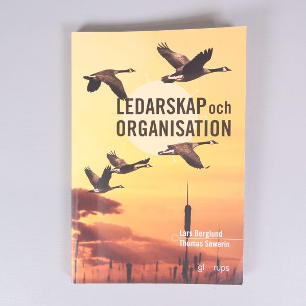 Boken Ledarskap och organisation sedd rakt uppifrån mot ljus bakgrund