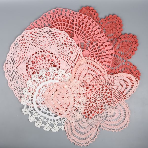 Röda och rosa virkade dukar spridda