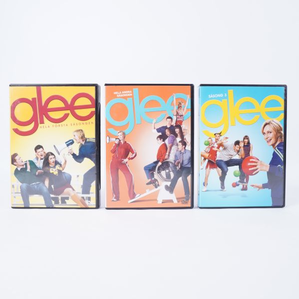Framsidorna på tre Glee DVD-fodral i olika färger