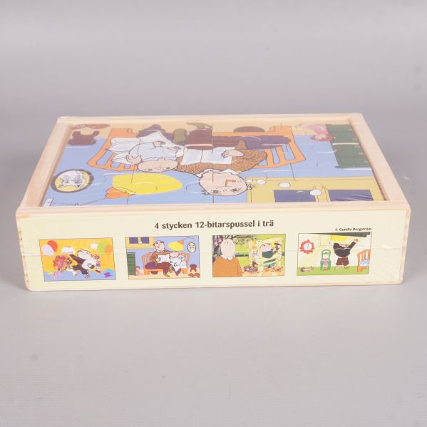 Sida av trälådan med bilder på fyra olika Alfons Åberg pussel