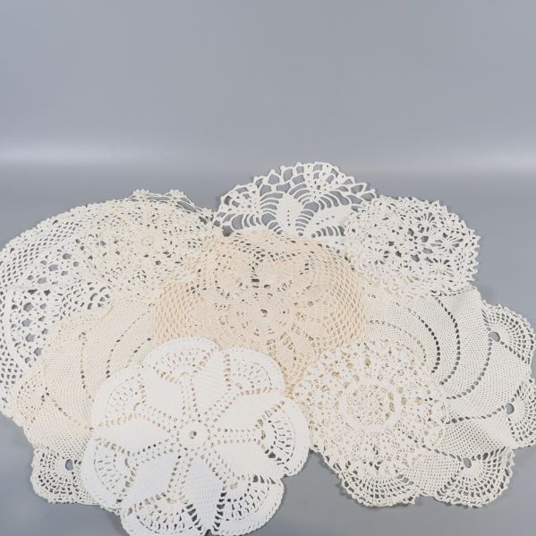 Flera virkade dukar i olika former och mönster utlagda