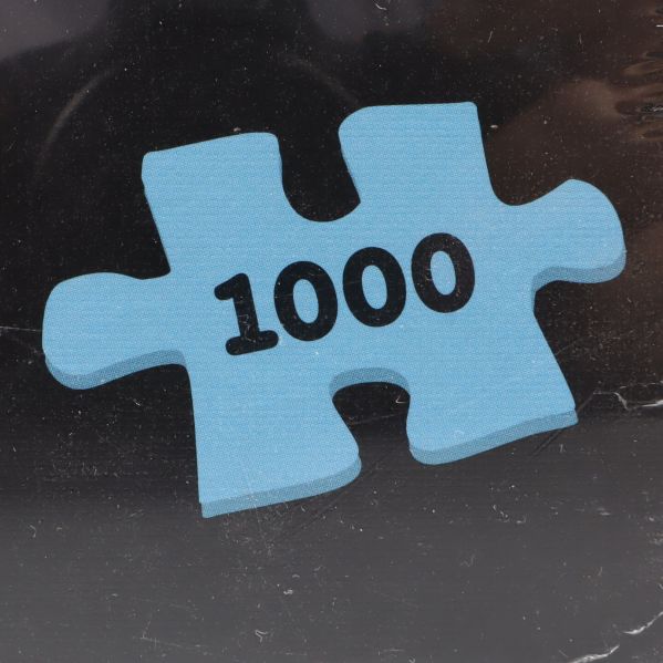 Närbild av blå pusselbit med texten 1000
