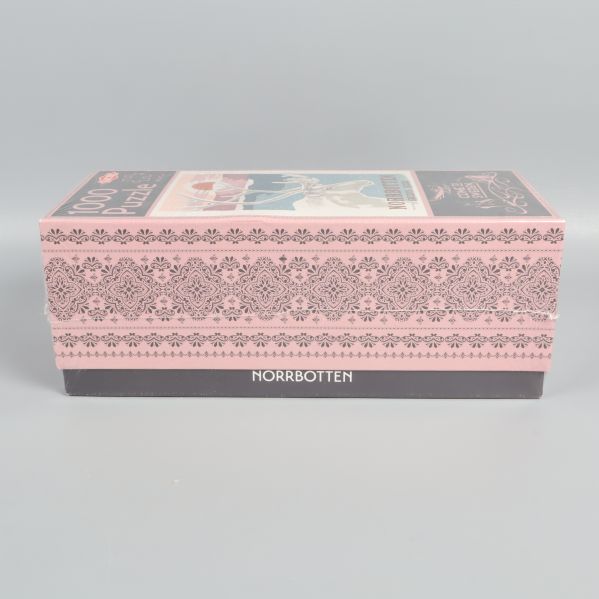 Långsida av pusselask med dekorativ kant och texten Norrbotten