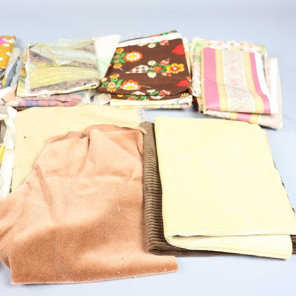 Närbild på tygbitar med bruna, gula och blommiga mönster