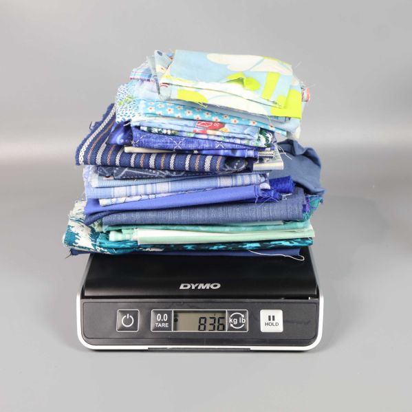 Våg visar tygbitar med total vikt 836 gram