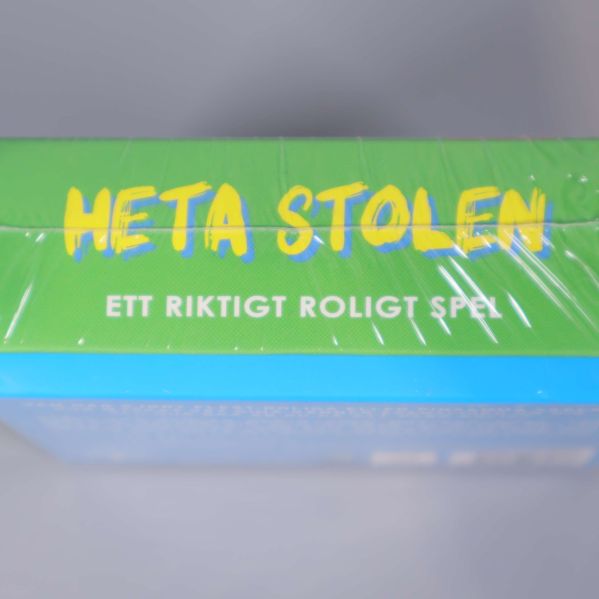 Överdel av Heta Stolen kartongen med speltext
