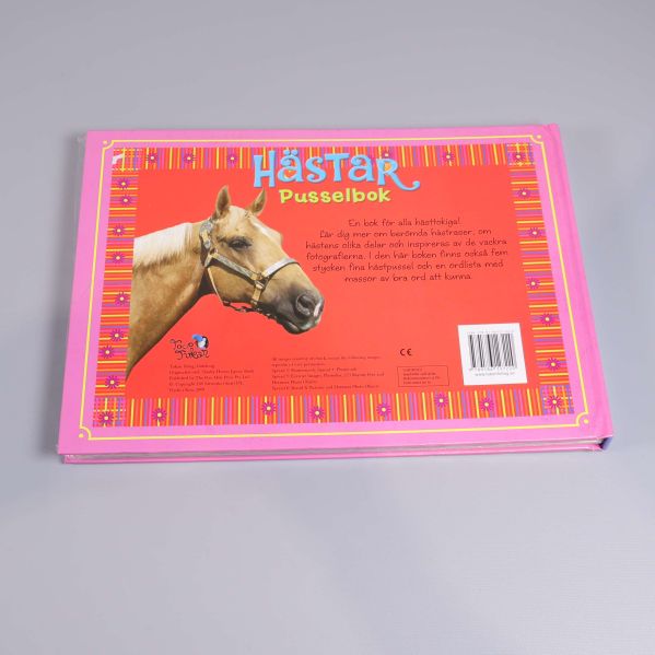Baksidan av pusselboken med häst och text