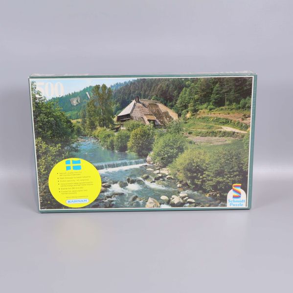 Pusselbox med landskapsmotiv och stor gul etikett