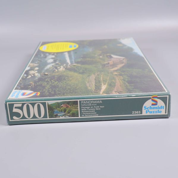 Pusselbox kant med panoramamotiv och logotyp