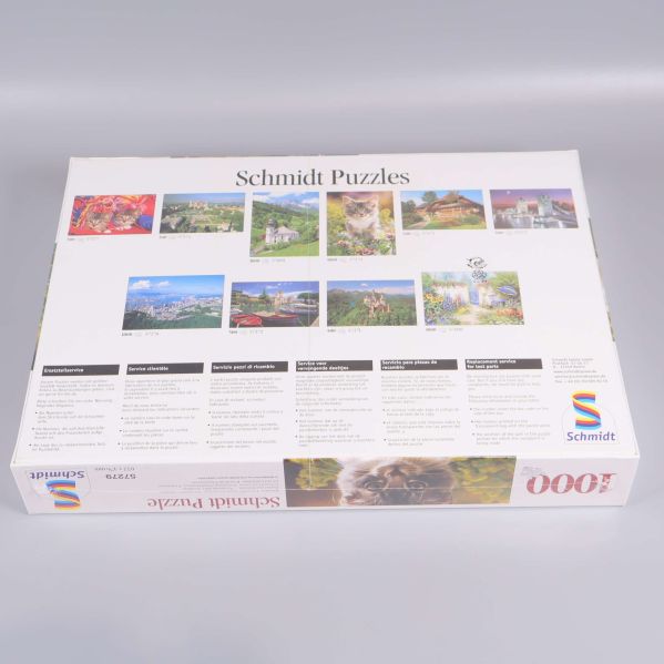 Baksidan på pussellådan visar fler motiv från Schmidt