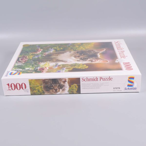 Pussellåda på sidan med Schmidt-logga och texten 1000