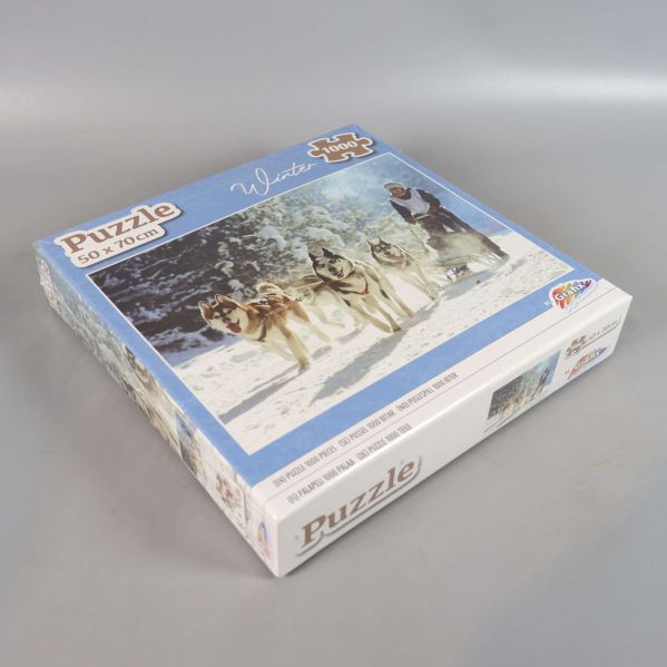 Pusselask med motiv av hundspann och snölandskap