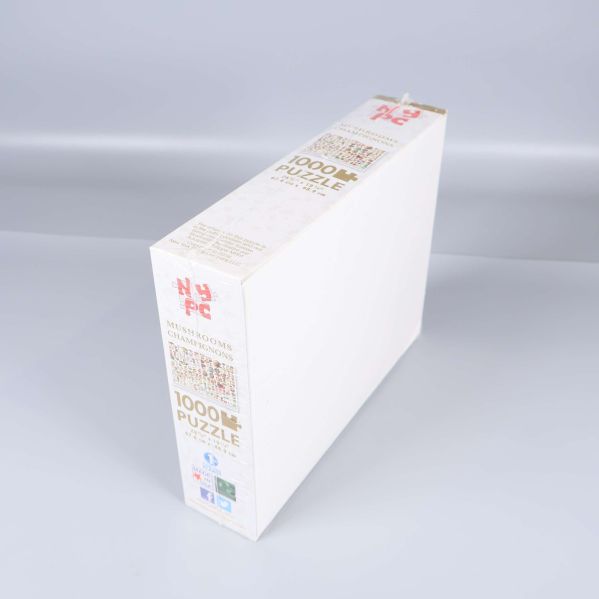 Sida av pusselask där 1000 bitar och logotyp syns