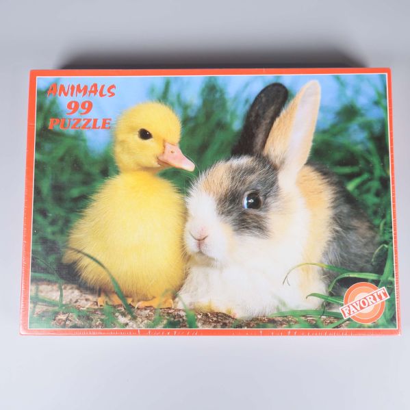 Pusselask med motiv av kanin och anka i gräs