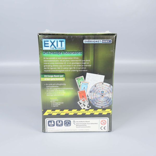 Baksidan av EXIT The Game visar spelkomponenter och text