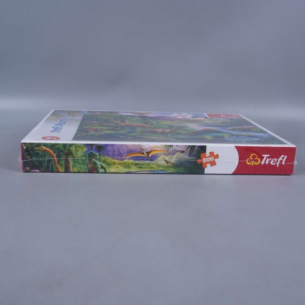 Sidan av pussellådan med motiv och Trefl-logga