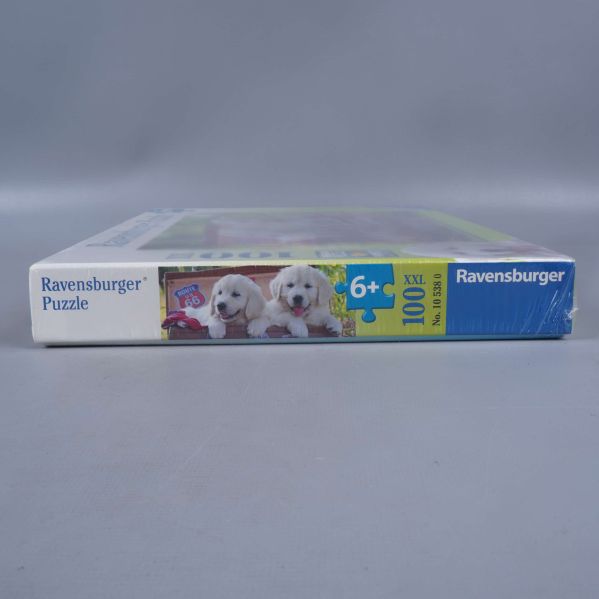 Sida av pusselask från Ravensburger med valpar och 100 XXL bitar