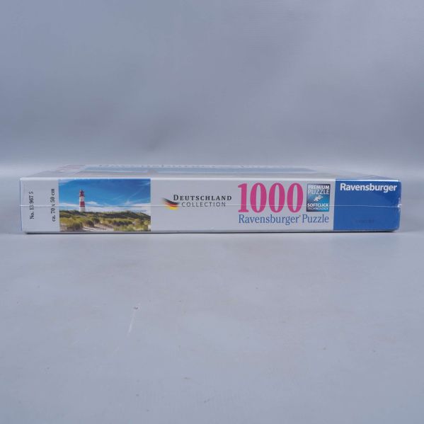 Sida av pusselask Ravensburger 1000 bitar med motiv och logga