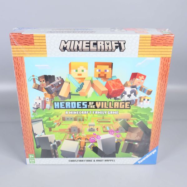 Framsidan av Minecraft Heroes of the Village sällskapsspel