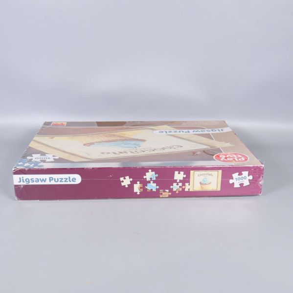 Andra långsidan av pussellådan med pusselmotiv