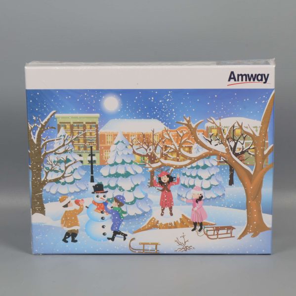 Framsida av pussellåda med vinterscen och Amway-logotyp