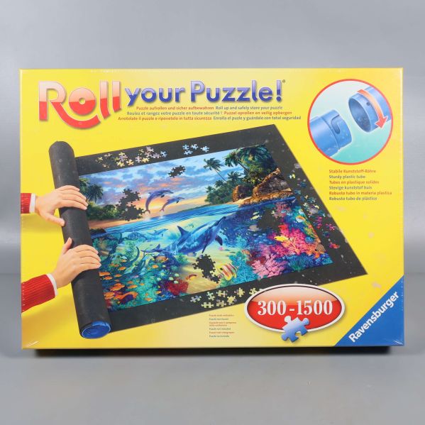 Framsida av Ravensburger pusselmatta i gul förpackning