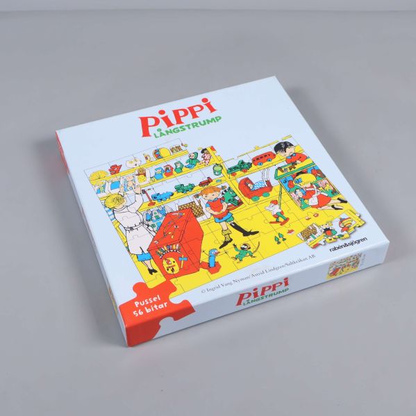 Pussellåda i vinkel med detaljerad bild på framsidan