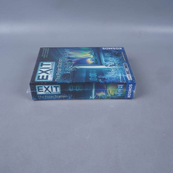 Exit The Game The Polar Station liggande på sidan på grått underlag