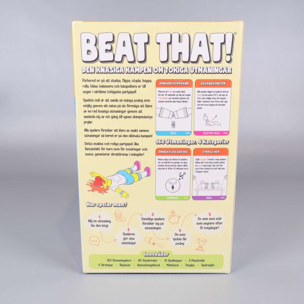 Baksidan av Beat That visar spelets beskrivning och exempel på utmaningar