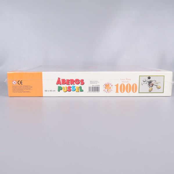 Sida av box med Åbergs pussel text och information