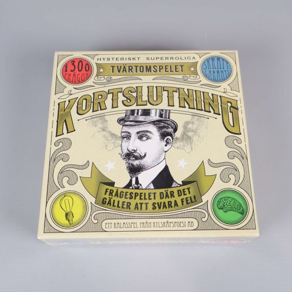 Framsidan av spelet Kortslutning med tecknad mustaschman och dekorativ text