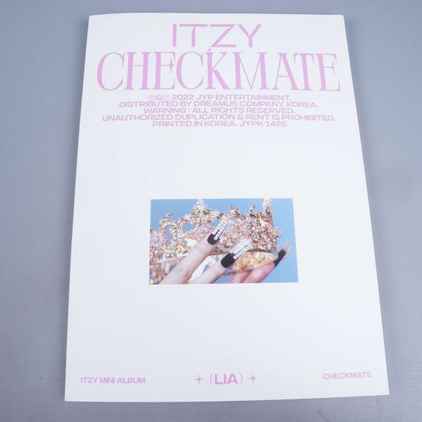 Framsida av ITZY Checkmate minialbum i vitt med hand och krona