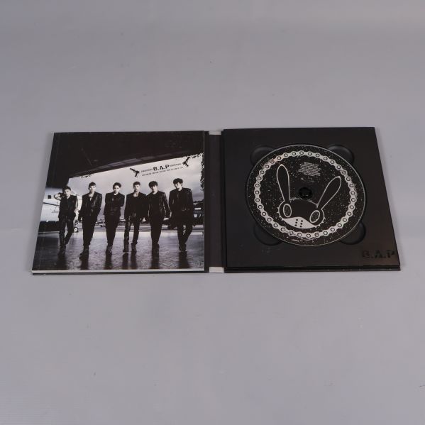 Uppslaget kpop-album visar cd och bandfoto