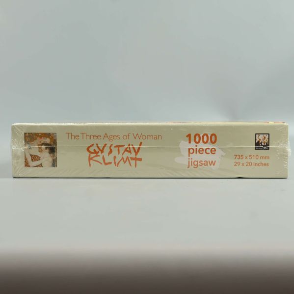 Pussellåda ovanifrån med motivet The Three Ages of Woman och 1000 piece-text