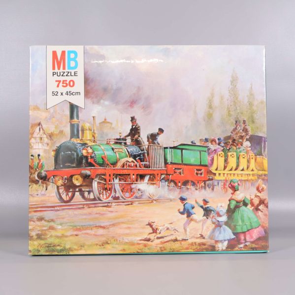 Färgglad pusselbox med tågmotiv och MB Puzzle-logotyp