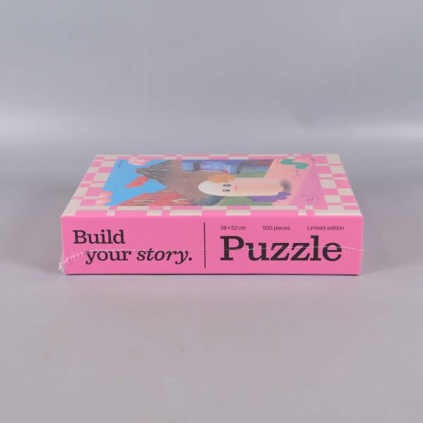 Nedre kant av asken med texten Build your story Puzzle