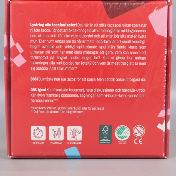 Närbild på baksidan av spelet Taco Tajm med produkttext och ikoner