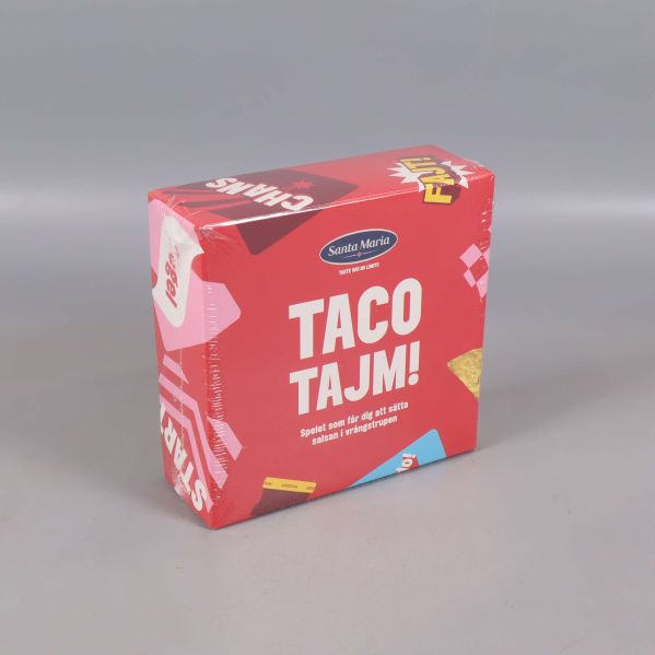 Taco Tajm sällskapsspel visat snett framifrån i röd förpackning