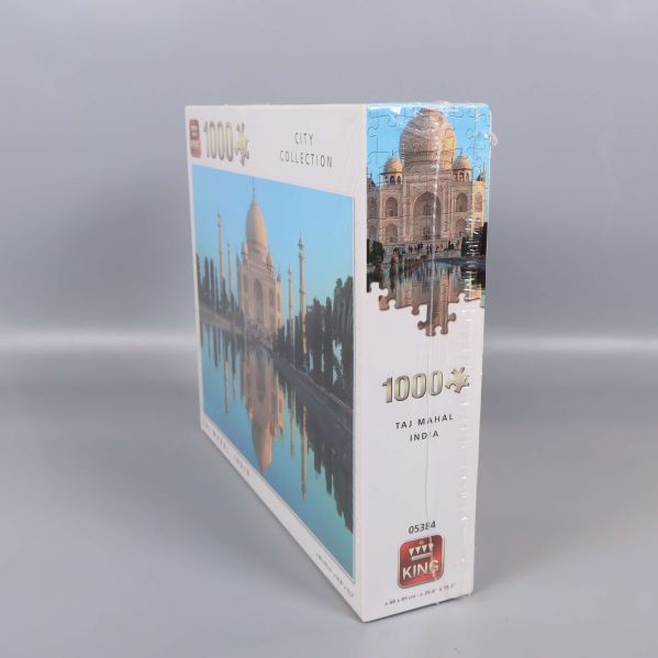 Sidovy av pusselasken med Taj Mahal och logotyp