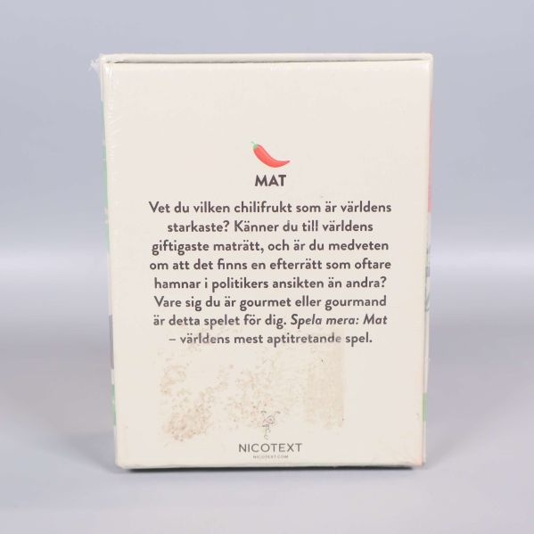 Framsidan av Mat-spelet med gröna och orangea illustrationer
