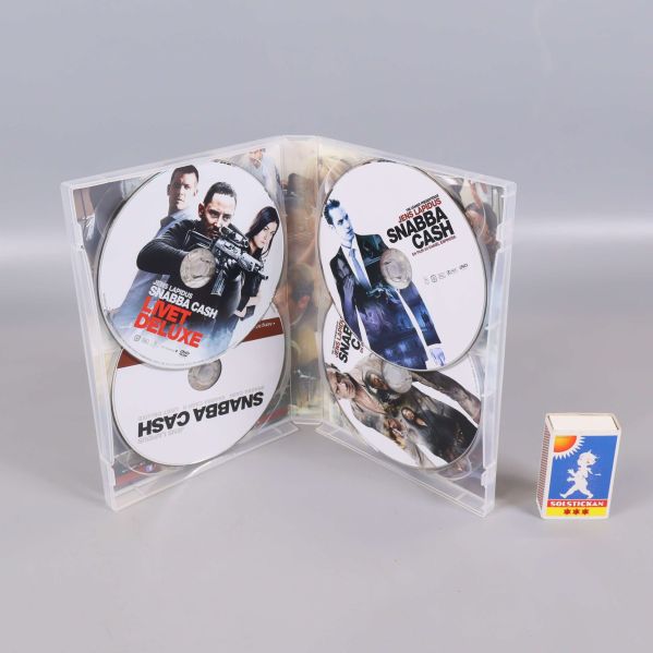 Öppet DVD-fodral med tre Snabba Cash-skivor och tändsticksask jämte