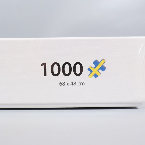Närbild på 1000 bitar och måttangivelse på pusselbox