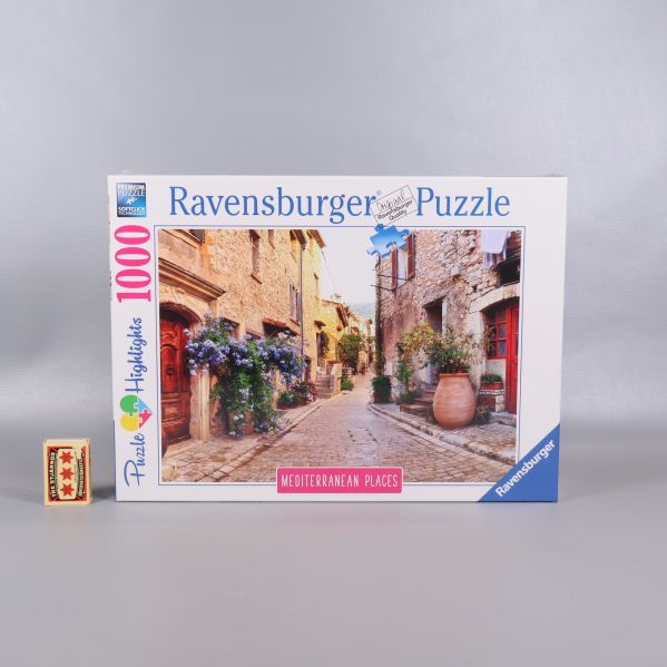 Ravensburger pusselask jämte storleksjämförelsekloss