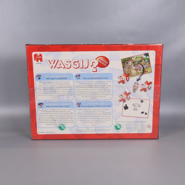 Wasgij jubileumspusslets baksida med instruktioner och spelbeskrivning