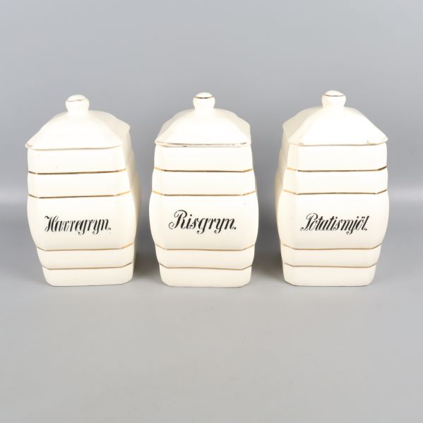 Tre vita burkar med tryckta etiketter