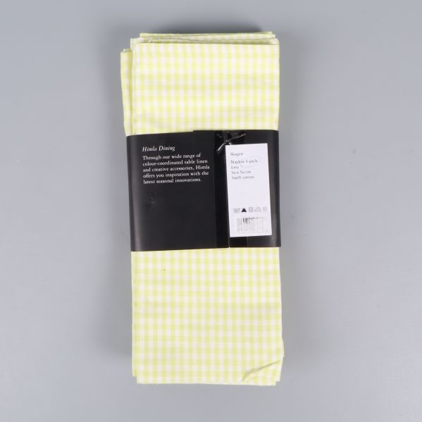 Baksida av servettförpackning med tvättinstruktioner och märke