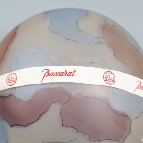 Närbild på Baccarat-märkt band kring glaskulan