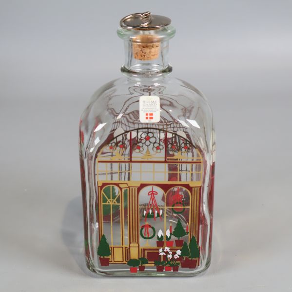 Karaff i glas med julmotiv och korklock framifrån