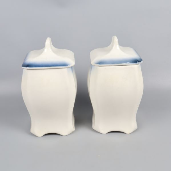 Baksidan av burkarna i vitt med blått lock